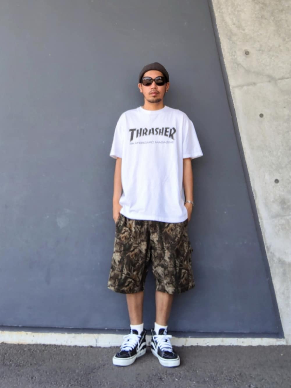 ホワイト系のTシャツ/カットソー、ブラウン系のその他パンツ、ブラック系のスニーカーを着用したメンズの夏コーディネートの2枚目の写真