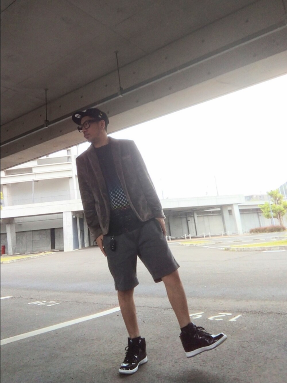 ブラック系のスニーカー、グレー系のジャケット/アウター、ブルー系のTシャツ/カットソーを着用したメンズの春コーディネートの2枚目の写真