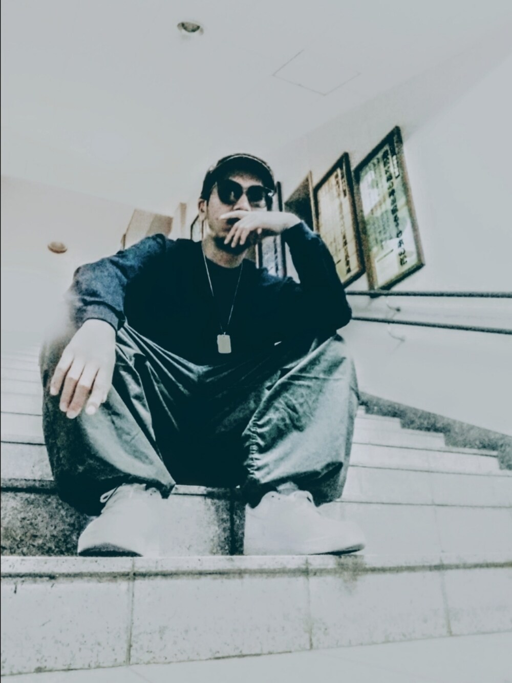 ブラック系のTシャツ/カットソー、グリーン系のその他パンツ、ホワイト系のスニーカーを着用したメンズの春コーディネートの3枚目の写真