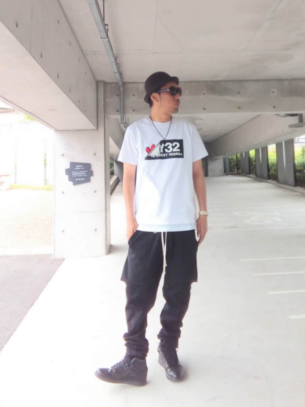 ホワイト系のTシャツ/カットソー、ブラック系のその他パンツ、ブラック系のスニーカーを着用したメンズの夏コーディネートの2枚目の写真