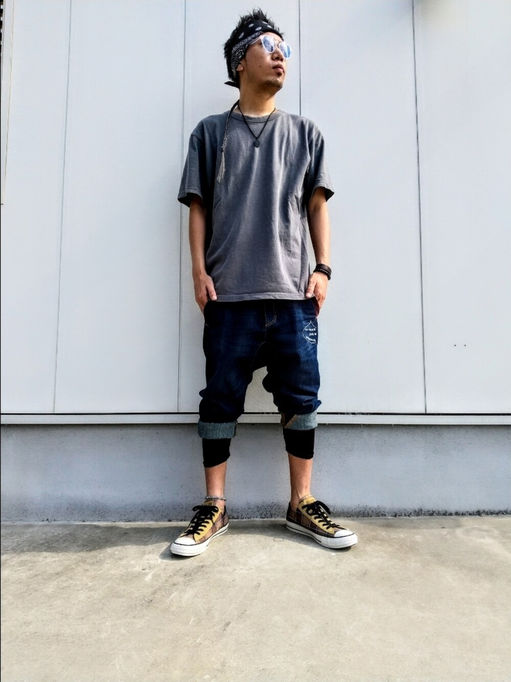 グレー系のTシャツ/カットソー、ブルー系のデニムパンツ、ベージュ系のスニーカーを着用したメンズの夏コーディネートの3枚目の写真