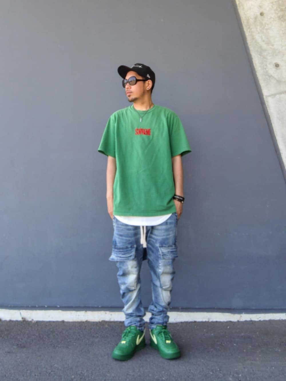 グリーン系のTシャツ/カットソー、ホワイト系のタンクトップ、ブルー系のデニムパンツを着用したメンズの春コーディネートの2枚目の写真
