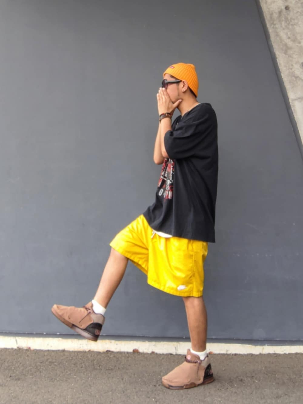 ブラック系のTシャツ/カットソー、イエロー系のその他パンツ、ブラウン系のスニーカーを着用したメンズの夏コーディネートの2枚目の写真