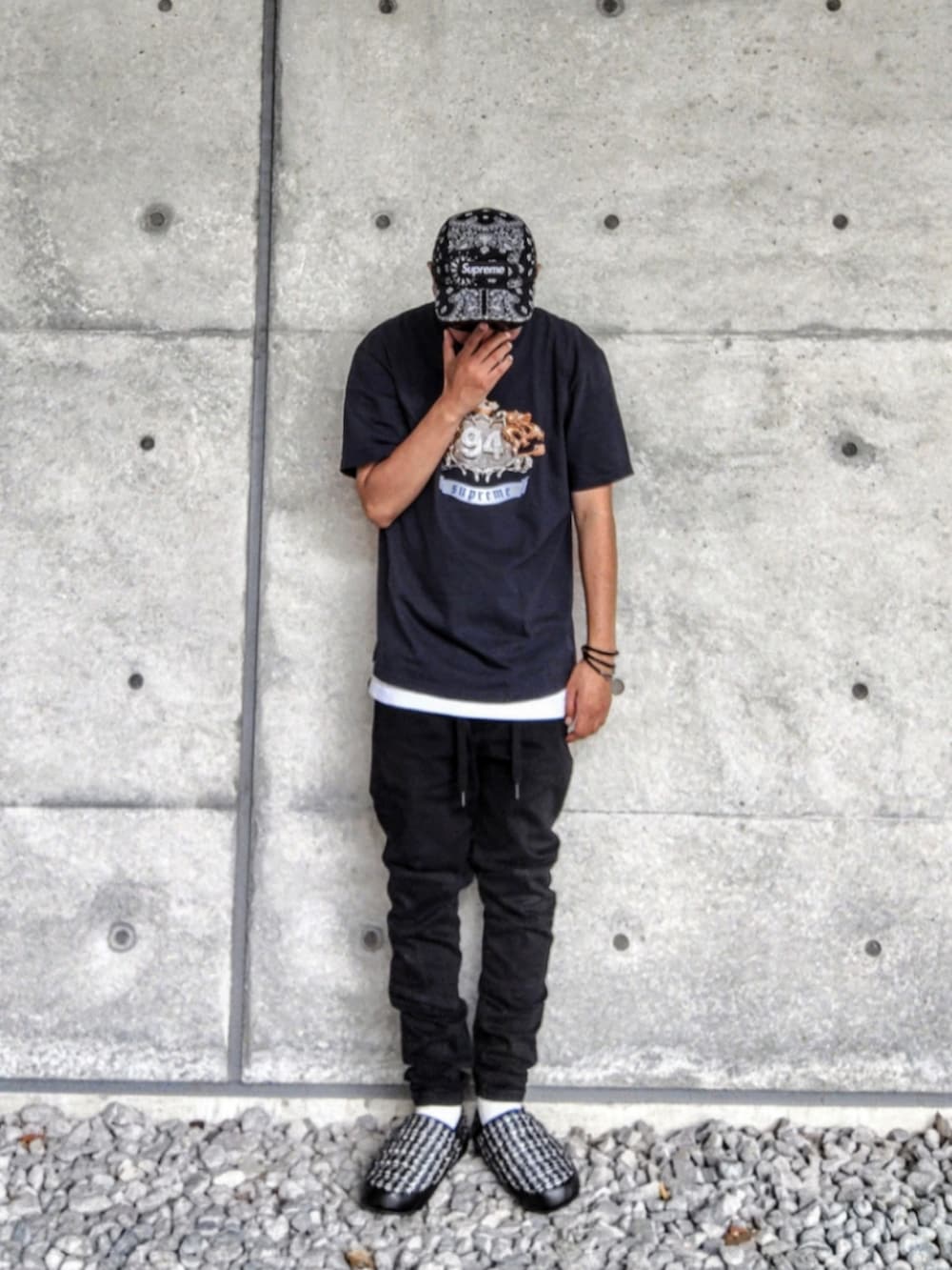 ブラック系のTシャツ/カットソー、ホワイト系のタンクトップ、ブラック系のデニムパンツを着用したメンズの夏コーディネートの2枚目の写真