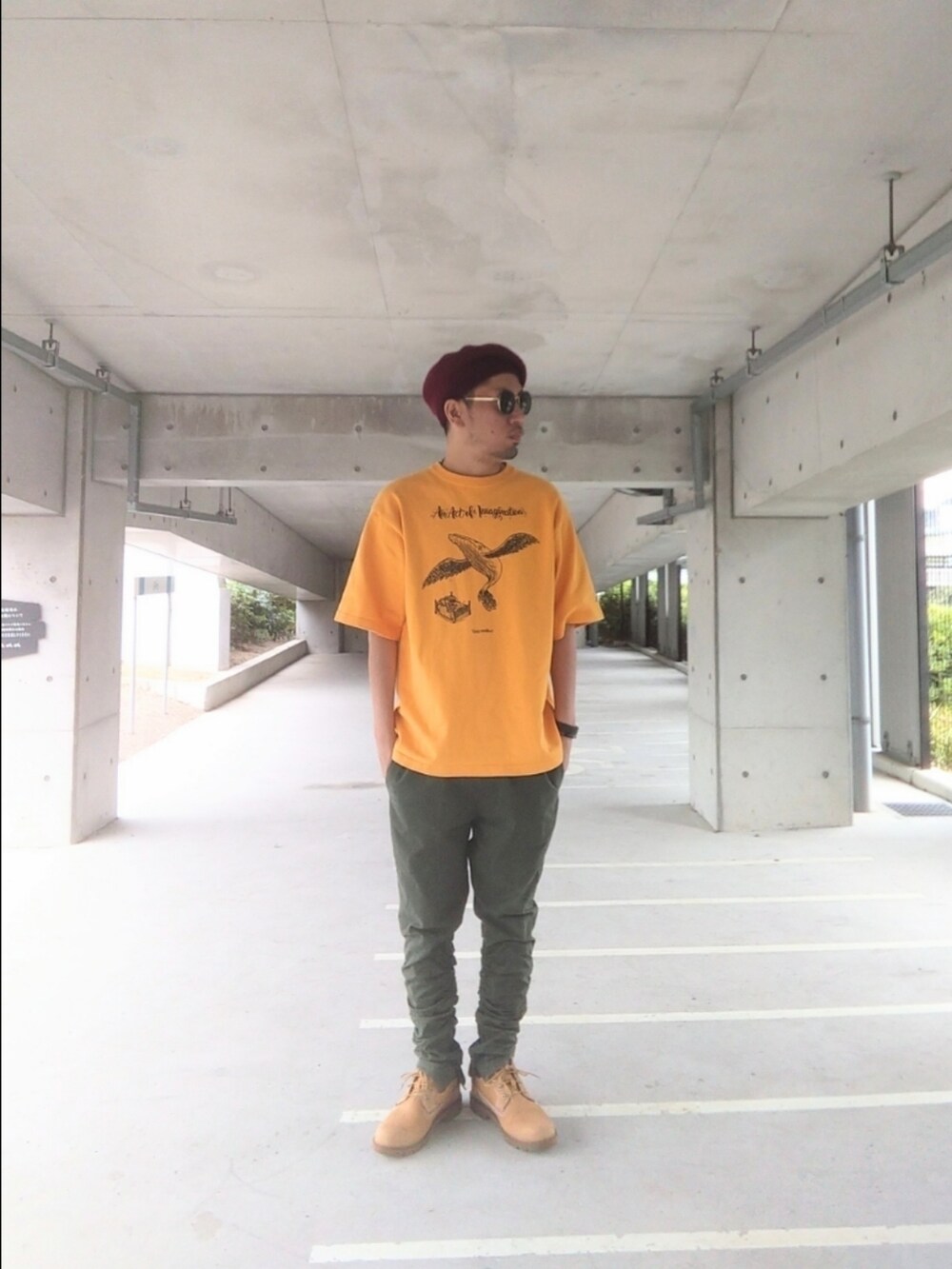 イエロー系のTシャツ/カットソー、グリーン系のパンツ、イエロー系のブーツを着用したメンズの秋コーディネートの2枚目の写真