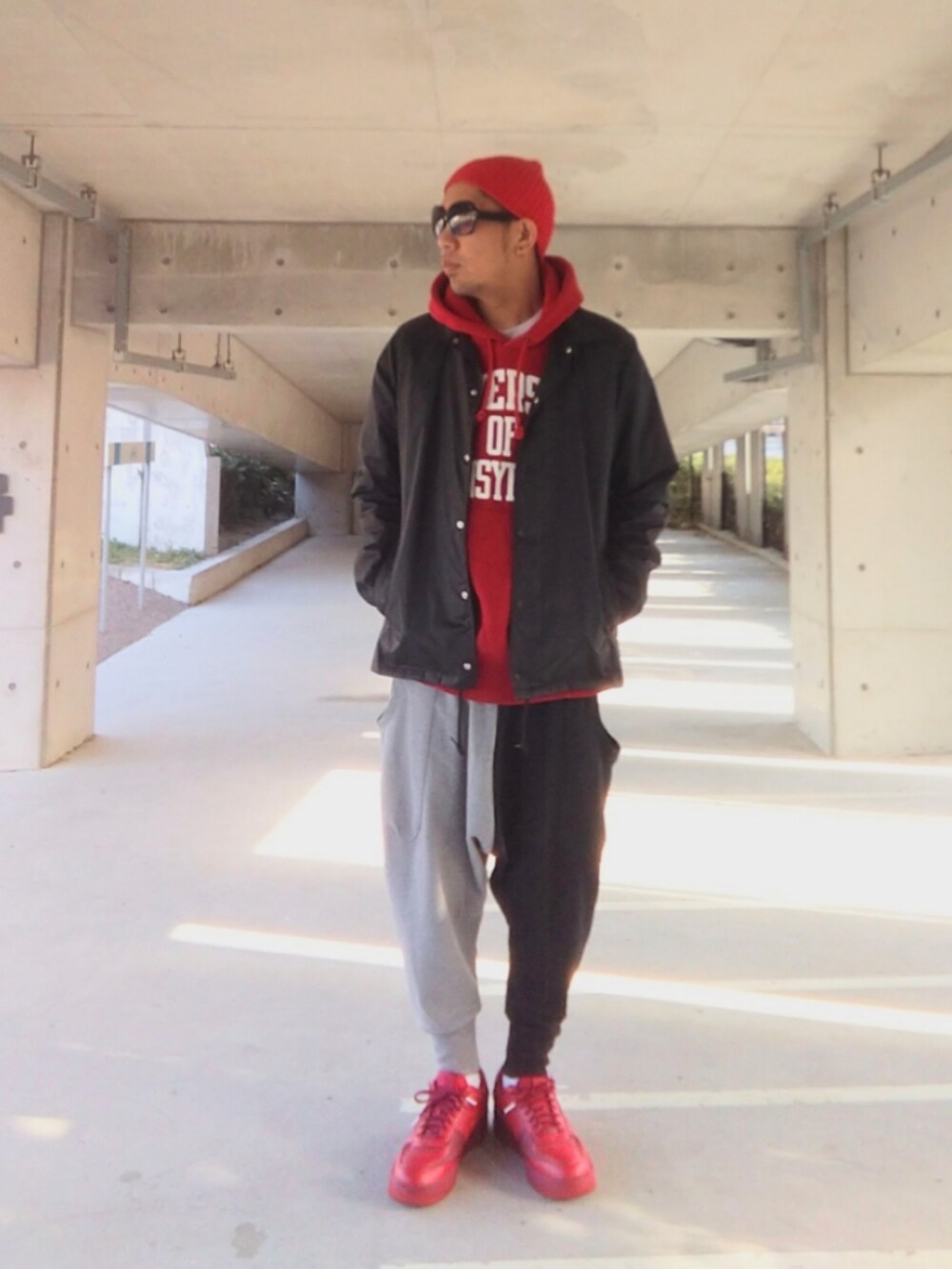 レッド系のパーカー、ブルー系のナイロンジャケット、その他のスウェットパンツを着用したメンズの冬コーディネートの3枚目の写真