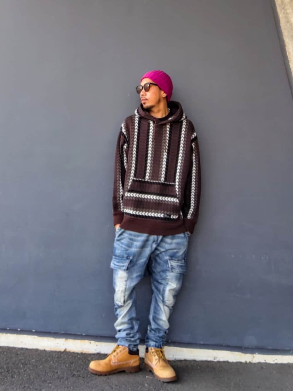 ブラウン系のパーカー、ブルー系のデニムパンツ、イエロー系のブーツを着用したメンズの冬コーディネートの3枚目の写真