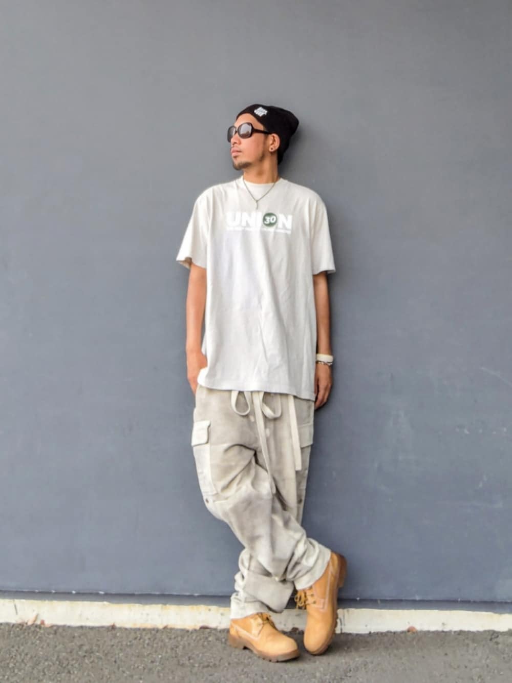 グレー系のTシャツ/カットソー、ホワイト系のその他パンツ、イエロー系のブーツを着用したメンズの夏コーディネートの2枚目の写真