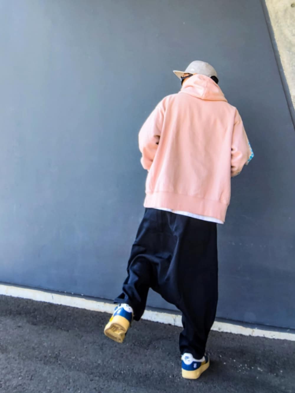 ピンク系のパーカー、ブラック系のその他パンツ、その他のスニーカーを着用したメンズの冬コーディネートの2枚目の写真