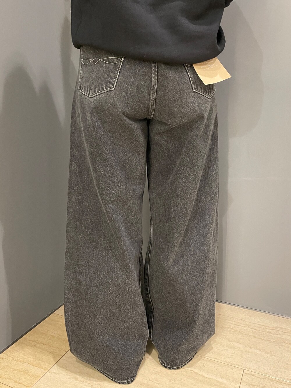 ブラック系のパーカー、ホワイト系のTシャツ/カットソー、ブラック系のデニムパンツを着用したレディースの秋コーディネートの9枚目の写真