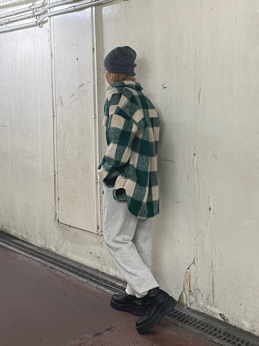 グリーン系のシャツ/ブラウス、ホワイト系のTシャツ/カットソー、ブラック系のブーツを着用したレディースの秋コーディネートの3枚目の写真