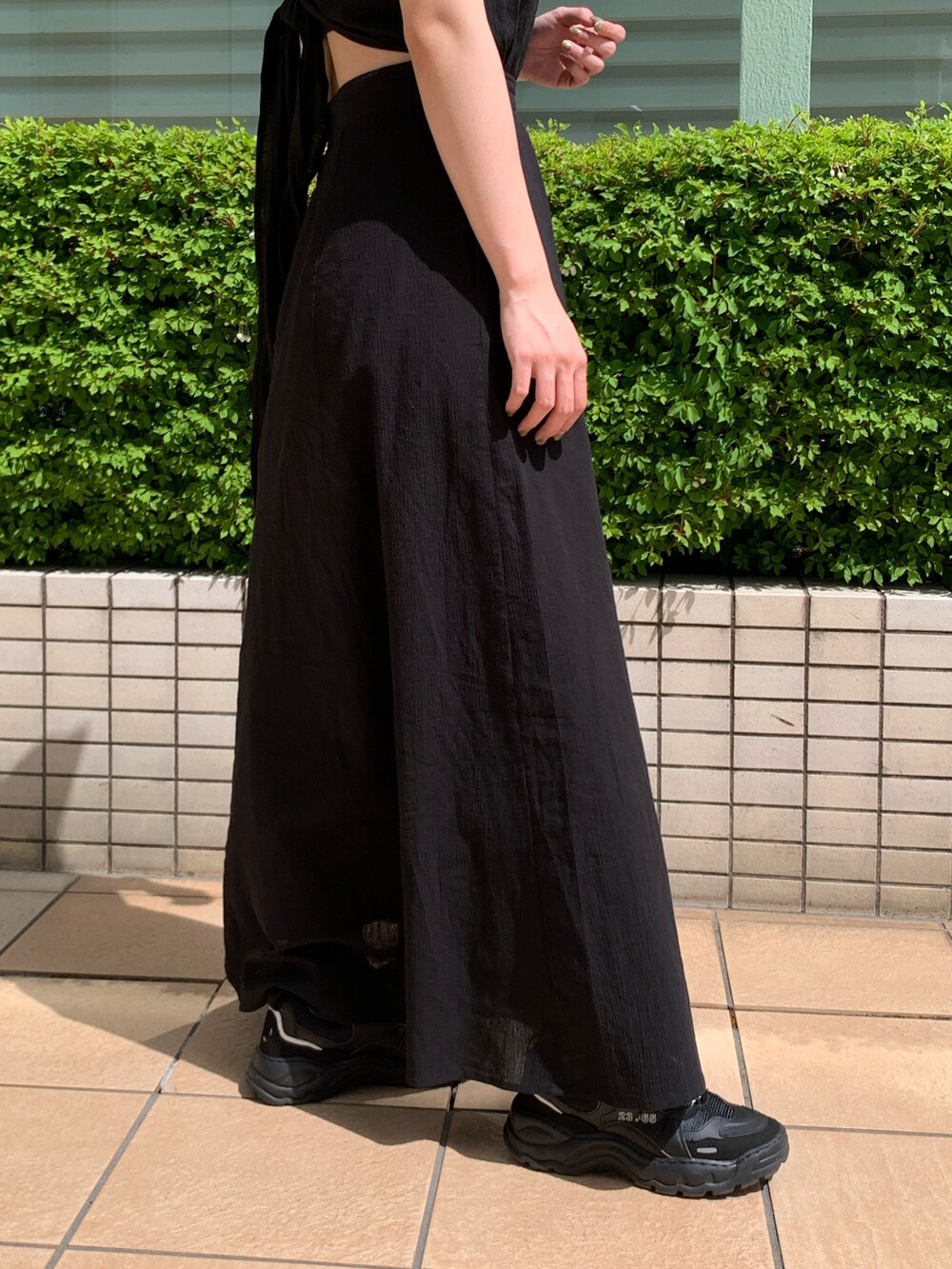 ブラック系のワンピースを着用したレディースの夏コーディネートの5枚目の写真