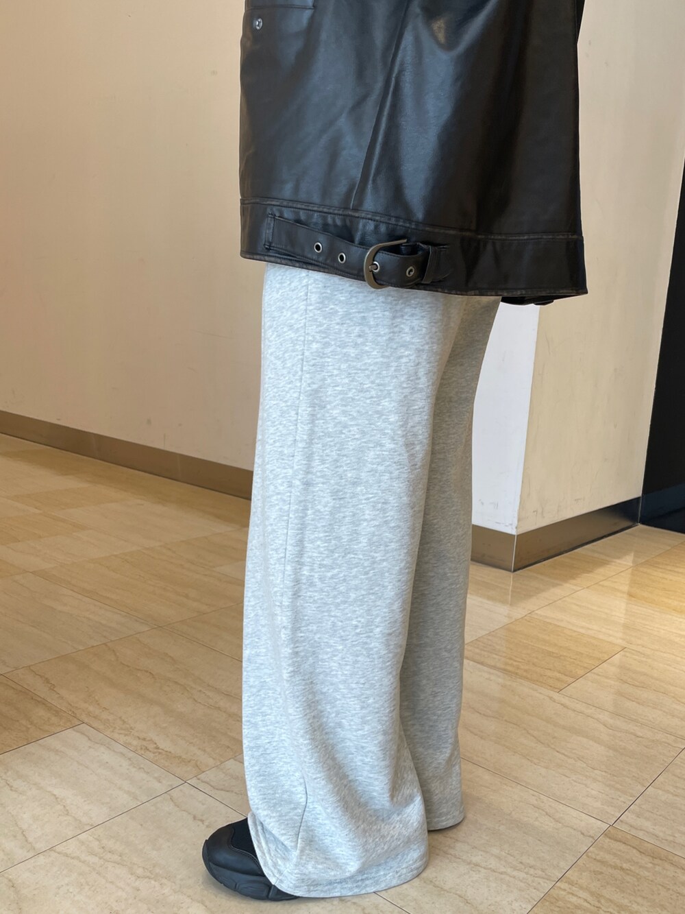 ブラック系のブルゾン、ブラウン系のニット/セーター、グレー系のスウェットパンツを着用したレディースの秋コーディネートの6枚目の写真