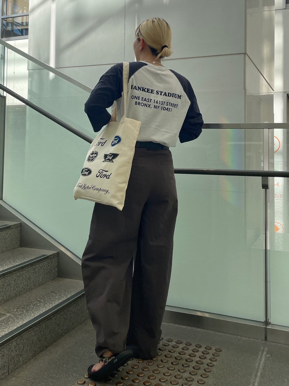 ブルー系のTシャツ/カットソー、ホワイト系のトートバッグ、グレー系のチノパンツを着用したレディースの夏コーディネートの3枚目の写真