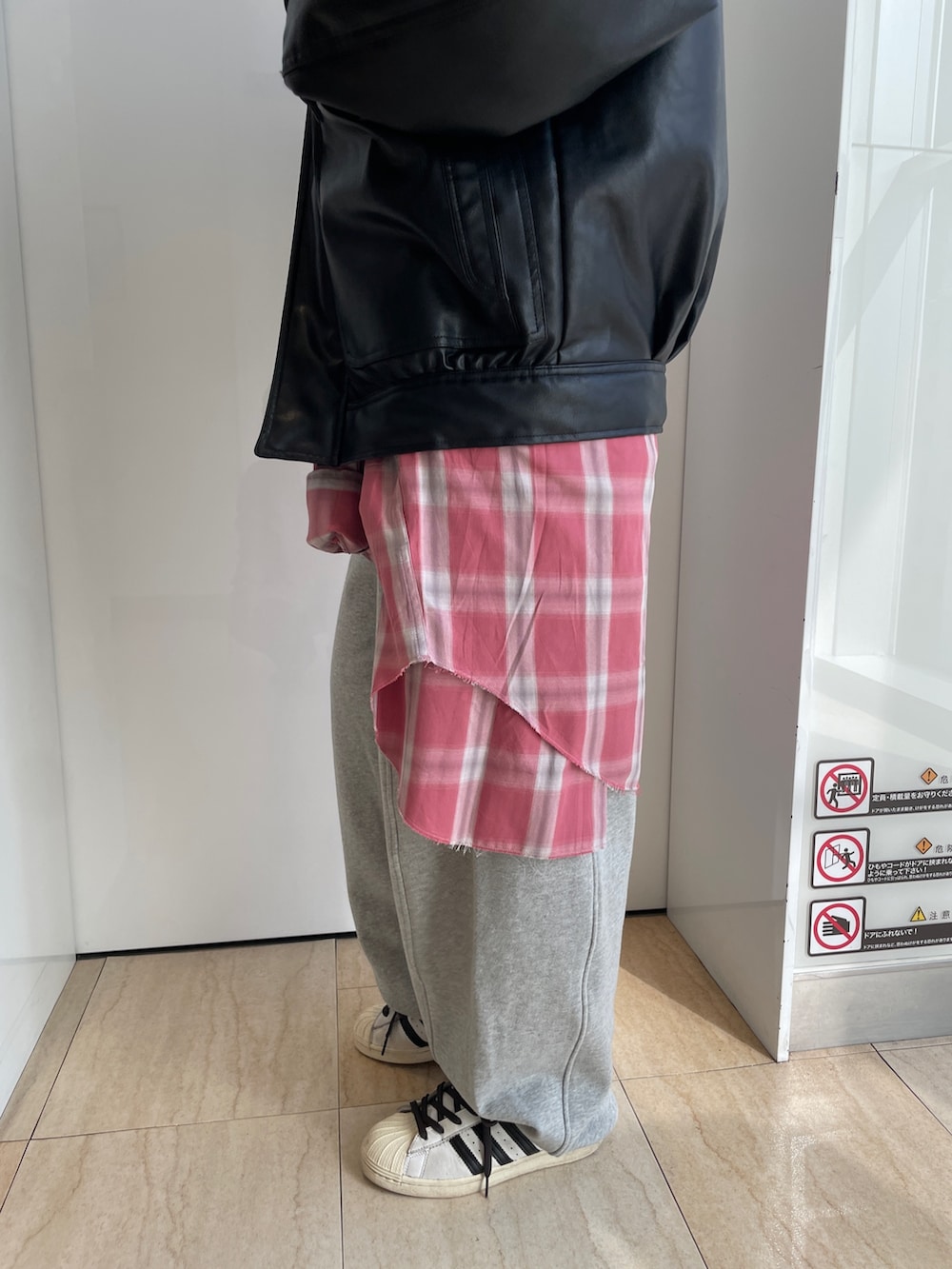 ブラック系のブルゾン、グレー系のパーカー、レッド系のシャツ/ブラウスを着用したレディースの冬コーディネートの9枚目の写真