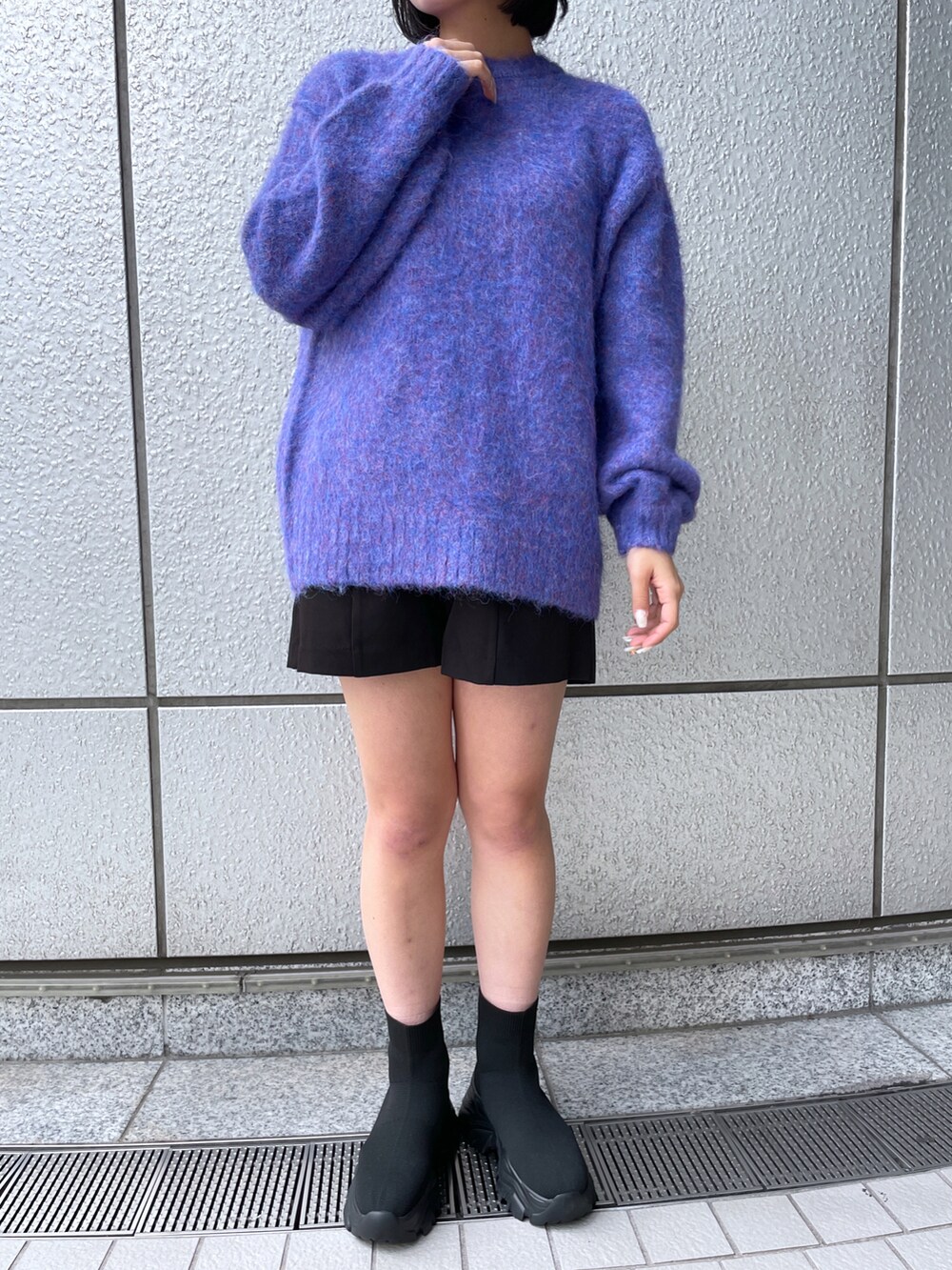ブルー系のニット/セーター、ブラック系のその他パンツ、ブラック系のブーツを着用したレディースの秋コーディネートの5枚目の写真