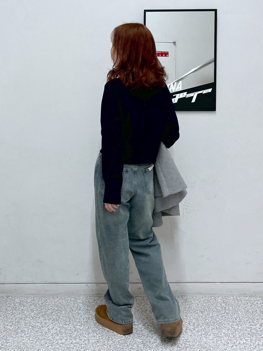 ブルー系のニット/セーター、グレー系のピーコート、ブラック系のショルダーバッグを着用したレディースの冬コーディネートの4枚目の写真