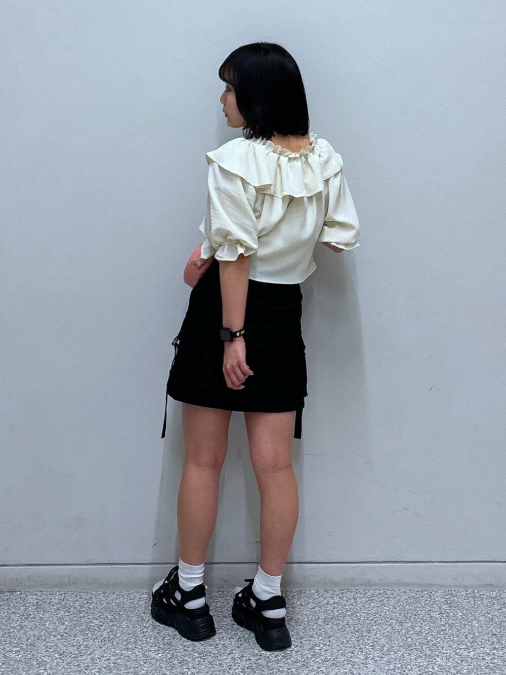 ブラック系のサンダル、ブラック系のスカート、ホワイト系のシャツ/ブラウスを着用したレディースの春コーディネートの4枚目の写真