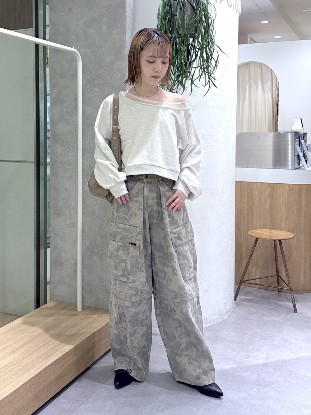 グリーン系のその他パンツ、ブラック系のブーツ、ホワイト系のTシャツ/カットソーを着用したレディースの春コーディネートの2枚目の写真