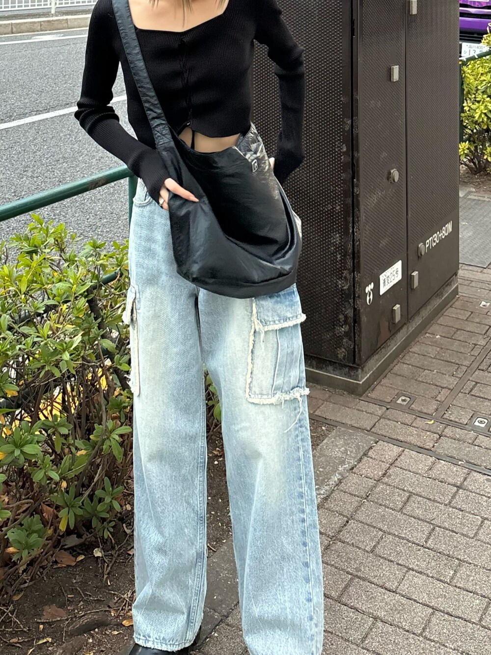 ブラック系のニット/セーター、ブルー系のデニムパンツ、ブラック系のハンドバッグを着用したレディースの冬コーディネートの2枚目の写真