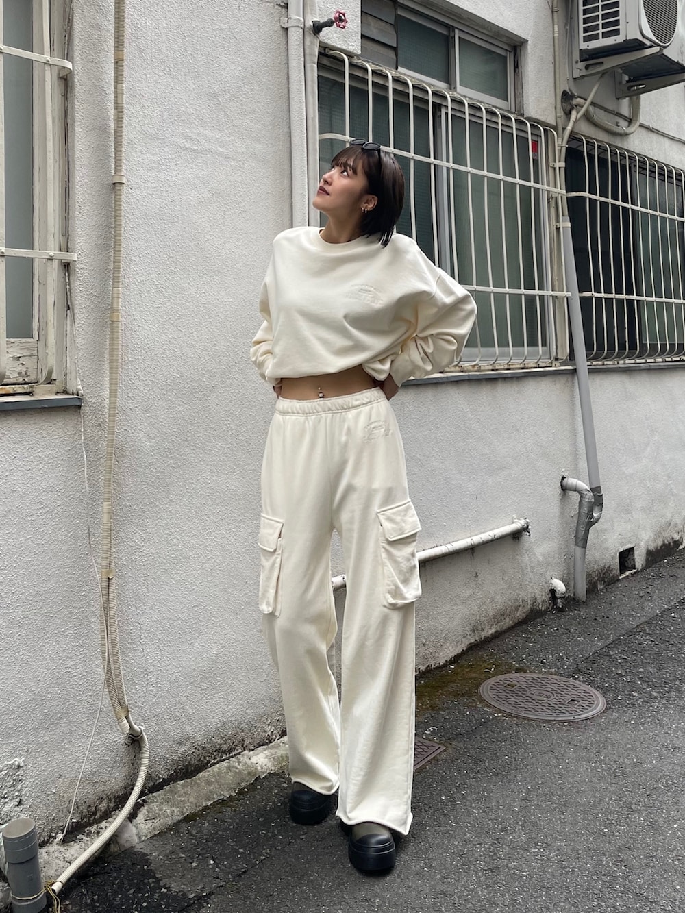 ホワイト系のスウェットパンツ、ホワイト系のTシャツ/カットソー、ベージュ系のブーツを着用したレディースの秋コーディネートの2枚目の写真