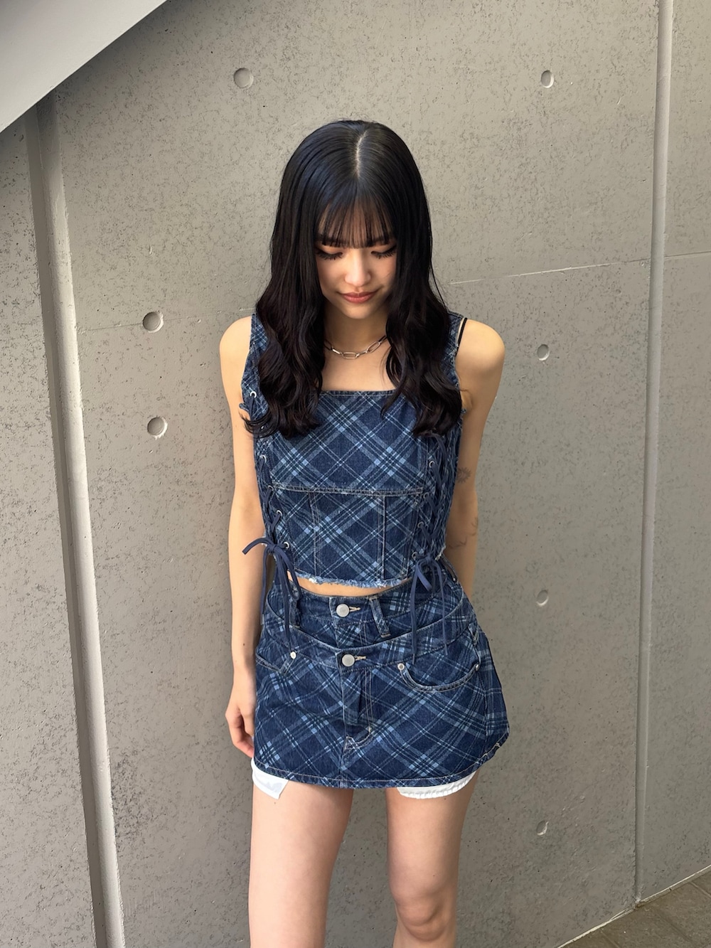 ブルー系のスカート、ブルー系のタンクトップ、ブラック系のサンダルを着用したレディースの冬コーディネートの2枚目の写真