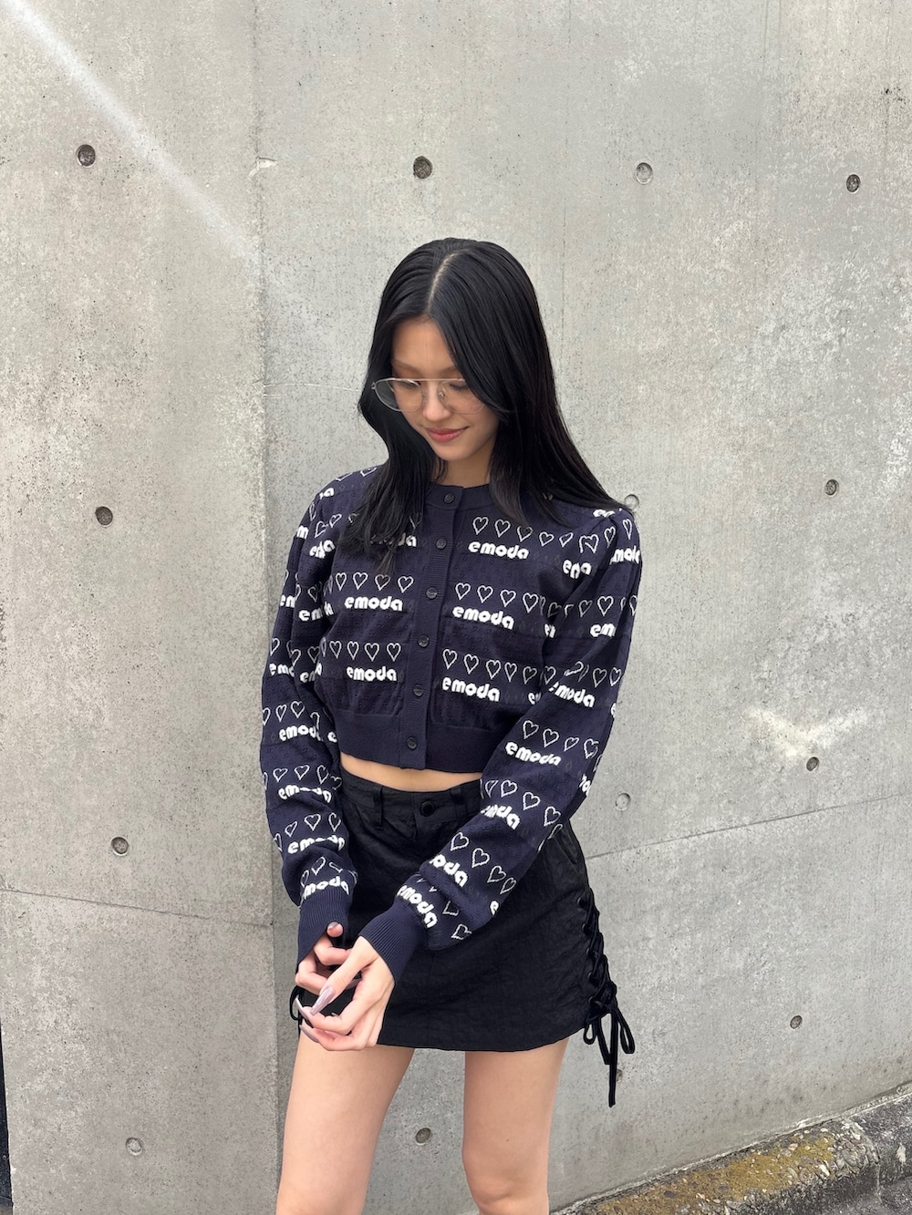 ブラック系のスカート、ブラック系のスニーカー、ブルー系のニット/セーターを着用したレディースの冬コーディネートの3枚目の写真