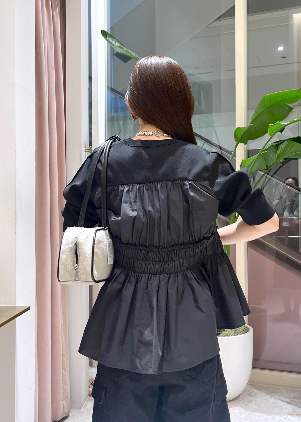 ベージュ系のサンダル、ホワイト系のボストンバッグ、ブラック系のカーディガン/ボレロを着用したレディースの春コーディネートの6枚目の写真