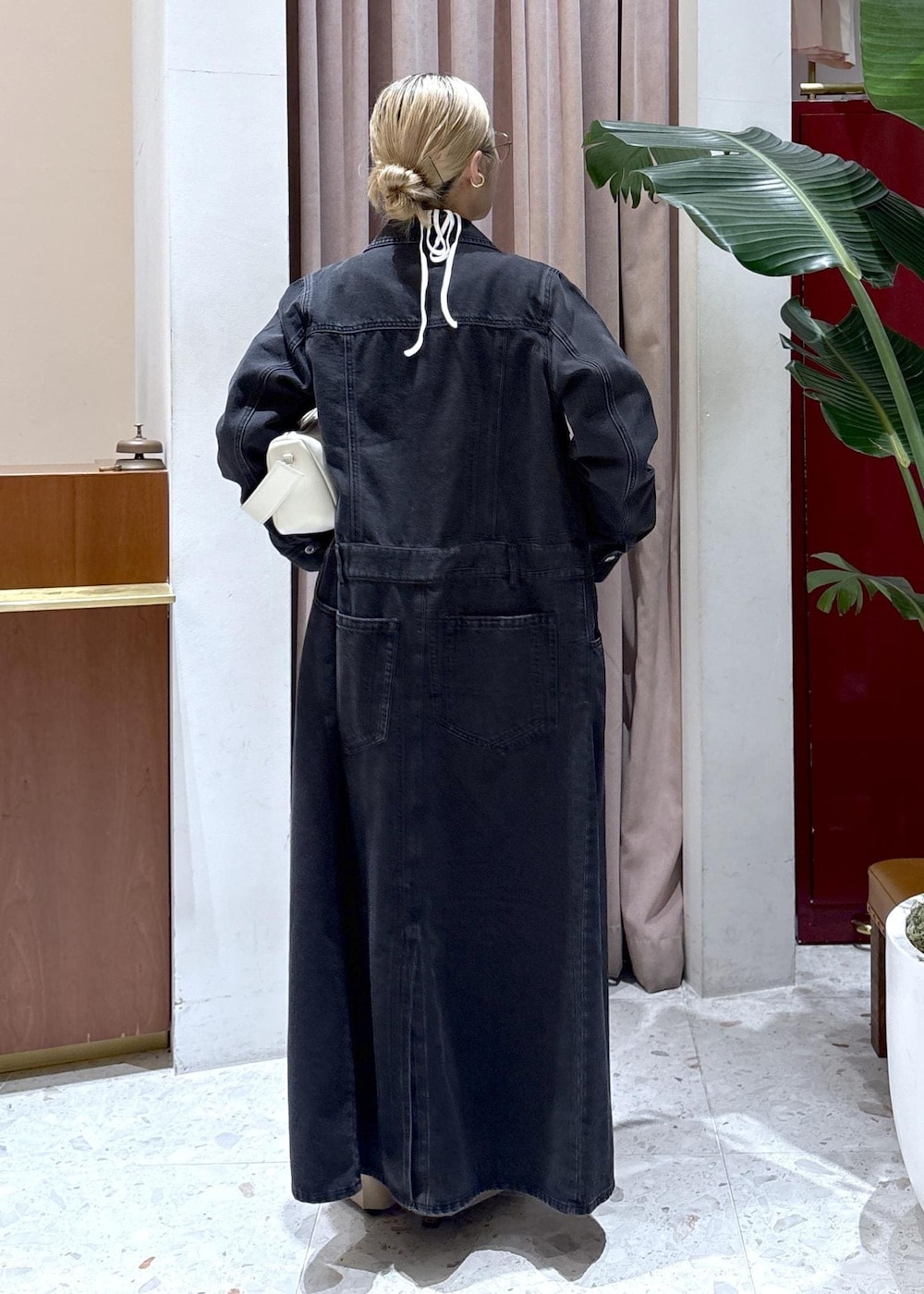 ホワイト系のハンドバッグ、ブラウン系のサンダル、ブラック系のワンピースを着用したレディースの春コーディネートの3枚目の写真