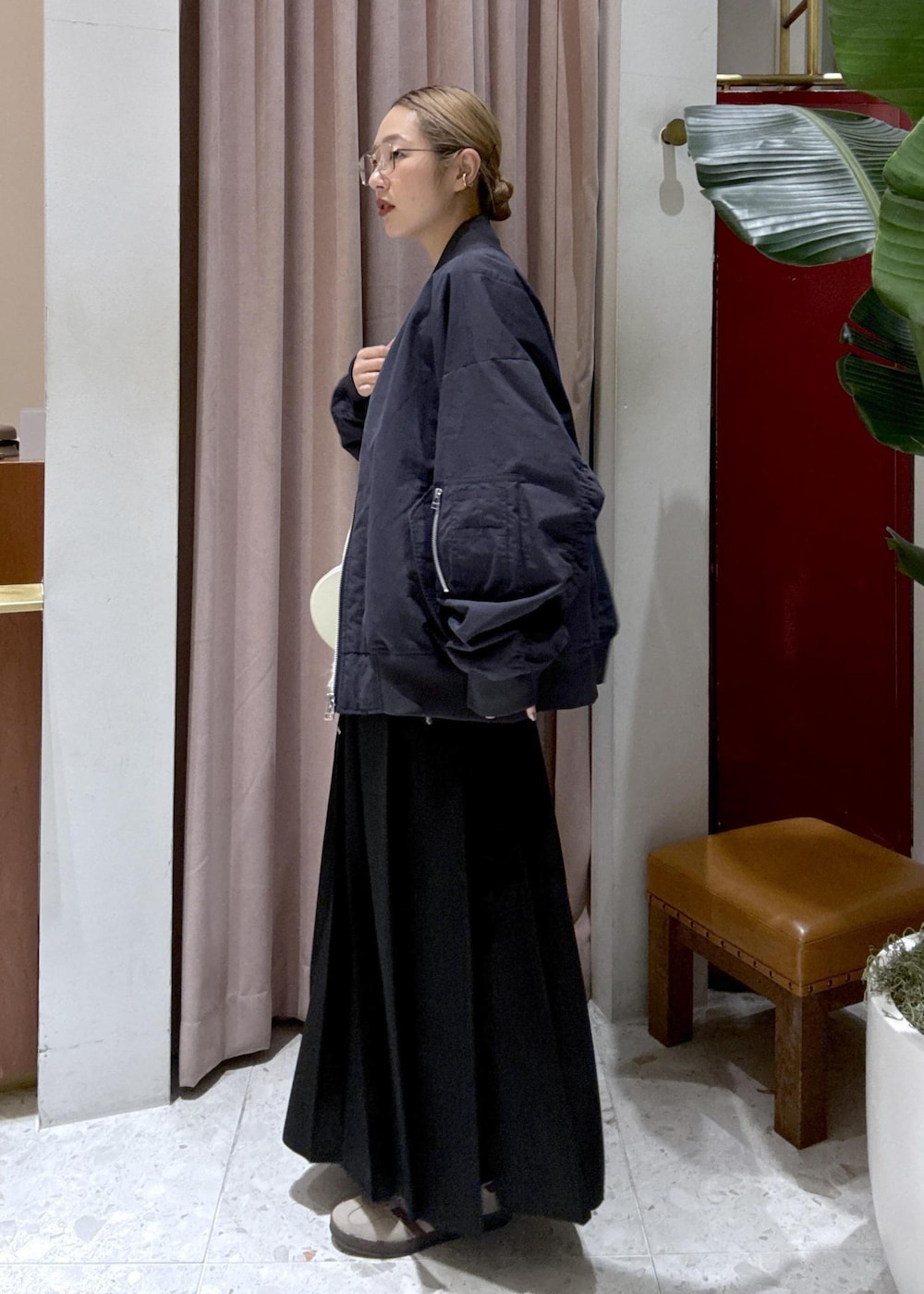 ブラック系のスカート、ベージュ系のスニーカー、ブルー系のMA-1を着用したレディースの冬コーディネートの3枚目の写真