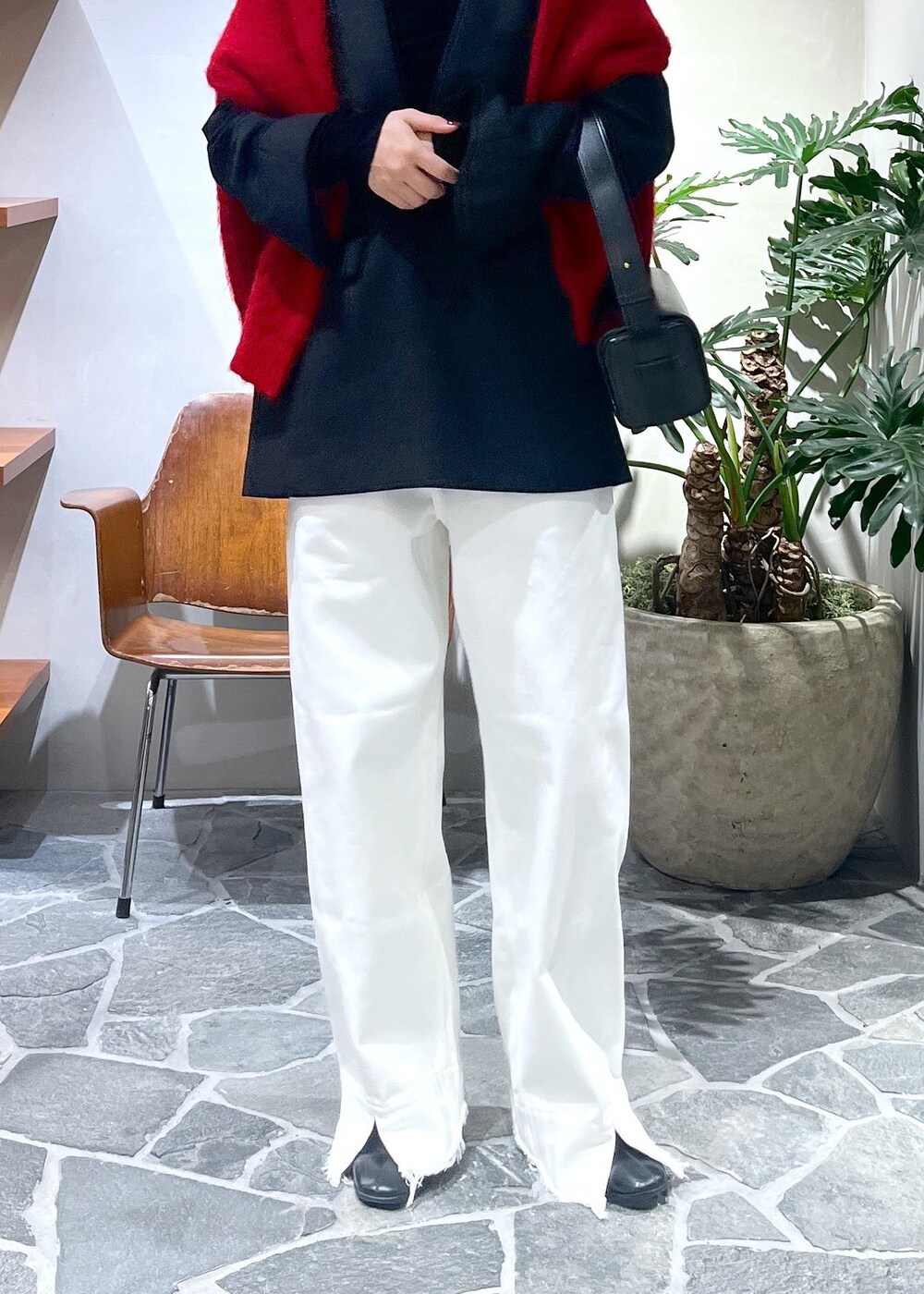 ブラック系のTシャツ/カットソー、ブラック系のシャツ/ブラウス、ホワイト系のデニムパンツを着用したレディースの冬コーディネートの4枚目の写真