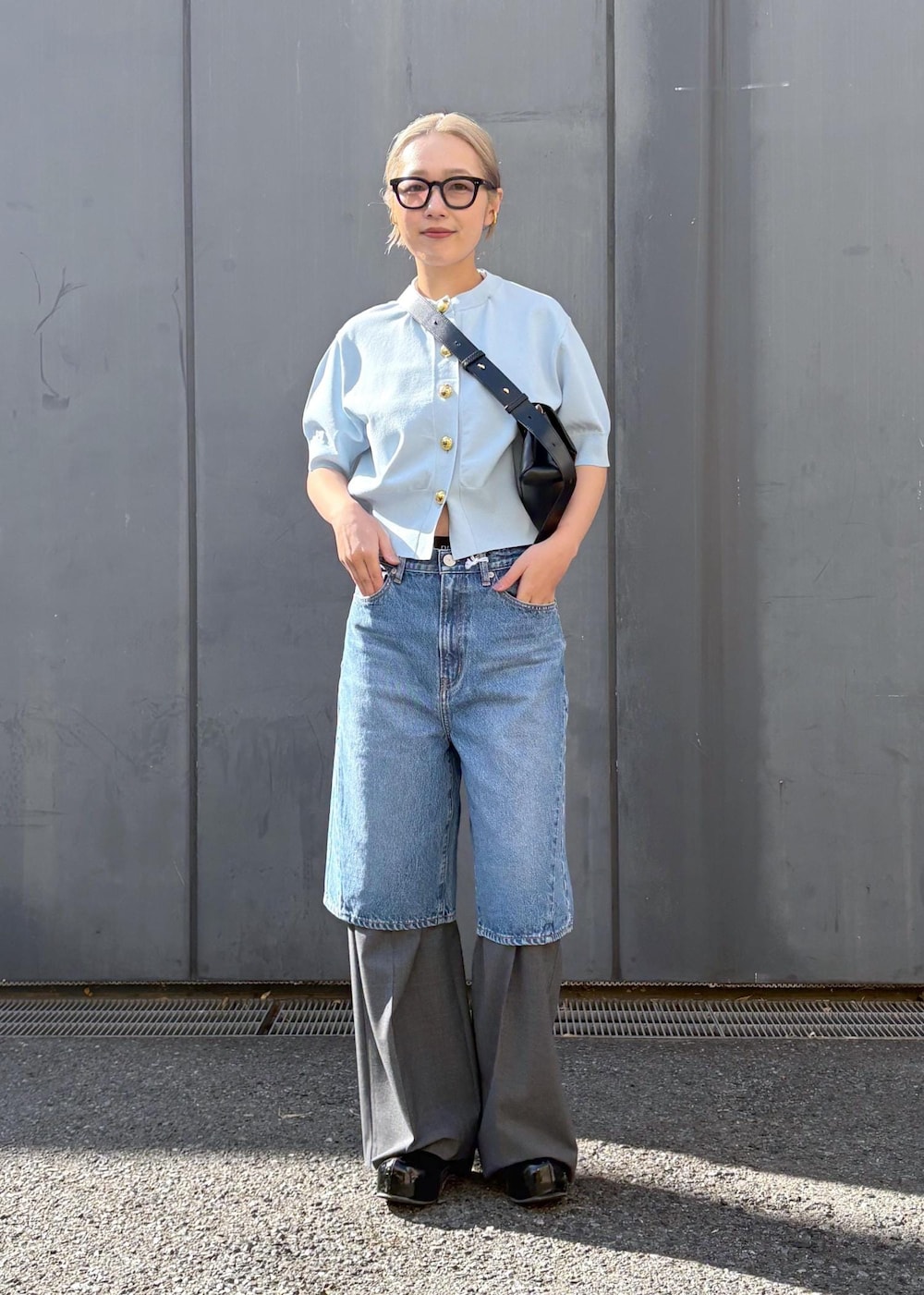 ブラック系のショルダーバッグ、グレー系のスラックスを着用したレディースの冬コーディネートの2枚目の写真