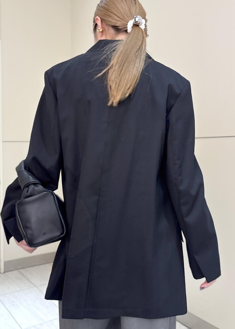 ホワイト系のパンプス、ブラック系のテーラードジャケット、ブルー系のつなぎ/オールインワンを着用したレディースの冬コーディネートの6枚目の写真