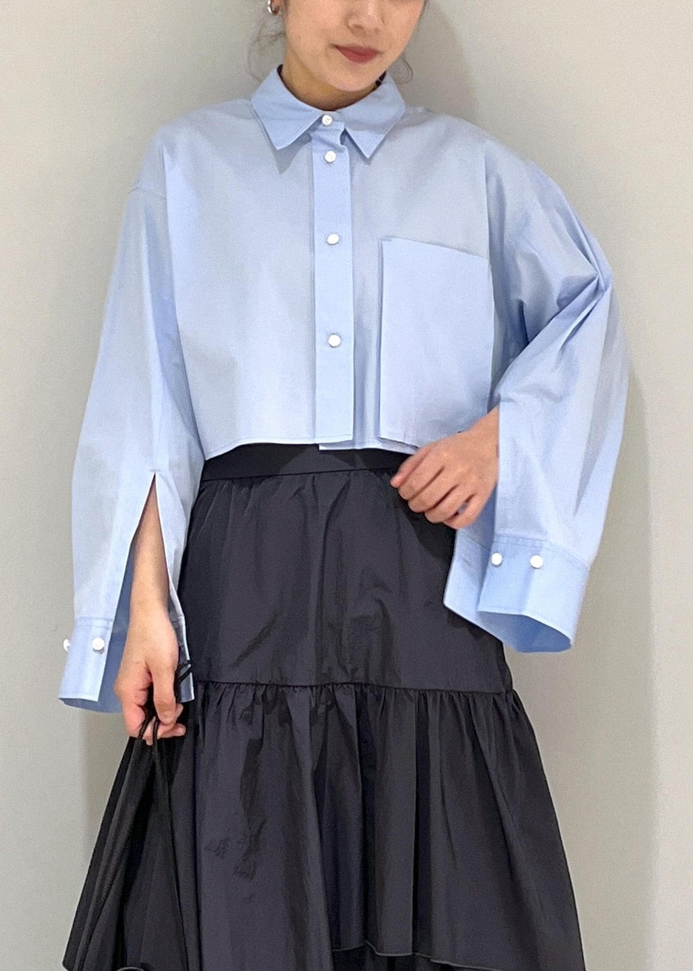 ブルー系のシャツ/ブラウス、ブラック系のショルダーバッグ、ブラック系のスカートを着用したレディースの春コーディネートの4枚目の写真