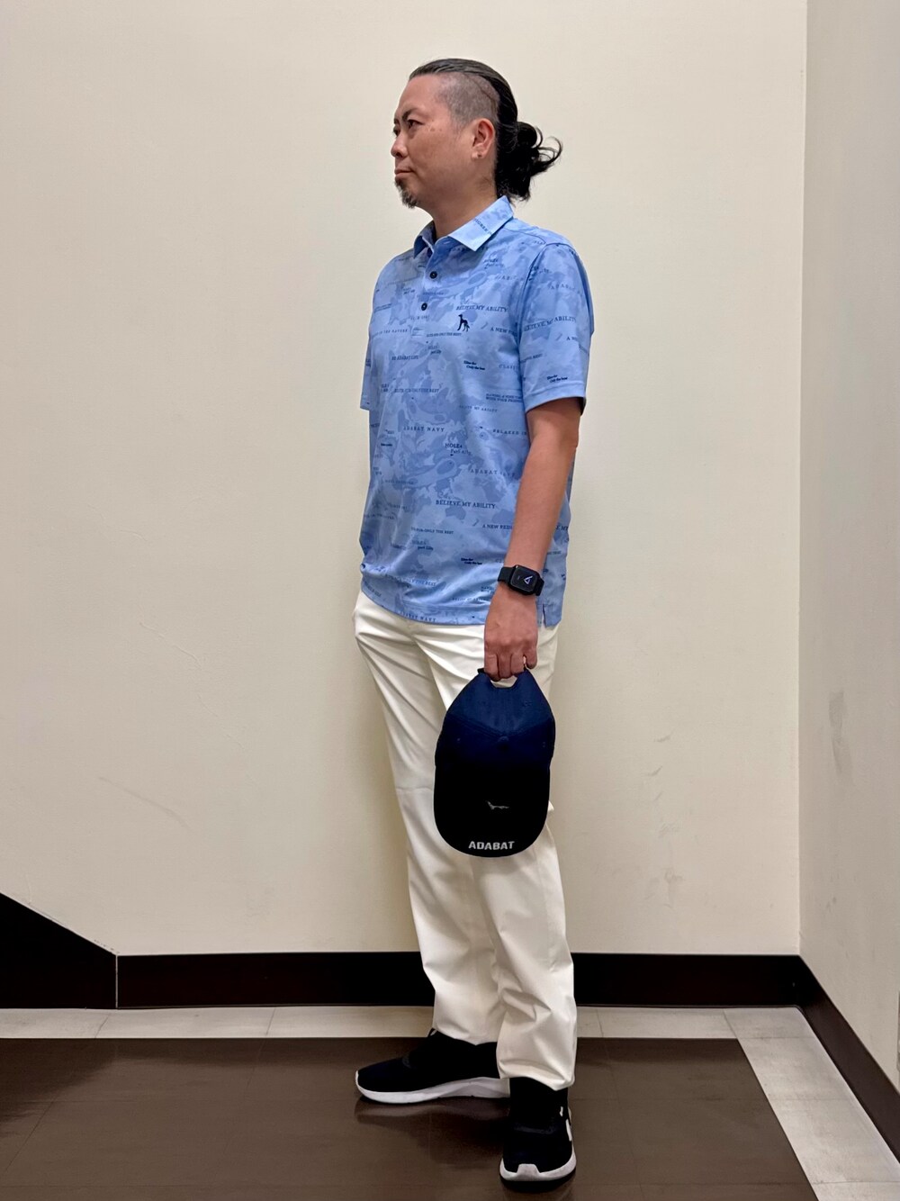 ブルー系のポロシャツ、ホワイト系のその他パンツ、ブルー系のキャップを着用したメンズの夏コーディネートの2枚目の写真