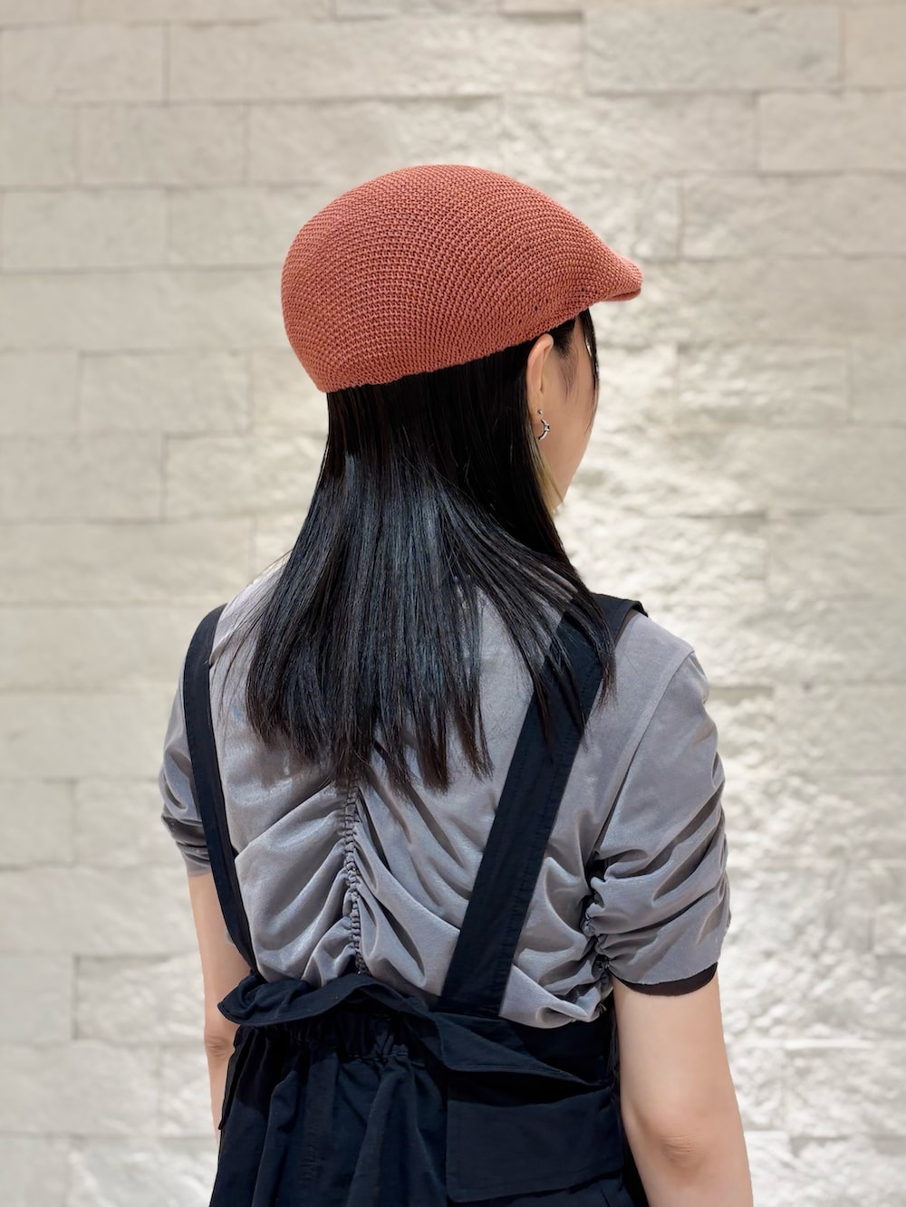 ブラック系のベスト、ブルー系のデニムパンツ、ベージュ系のスニーカーを着用したレディースの夏コーディネートの5枚目の写真