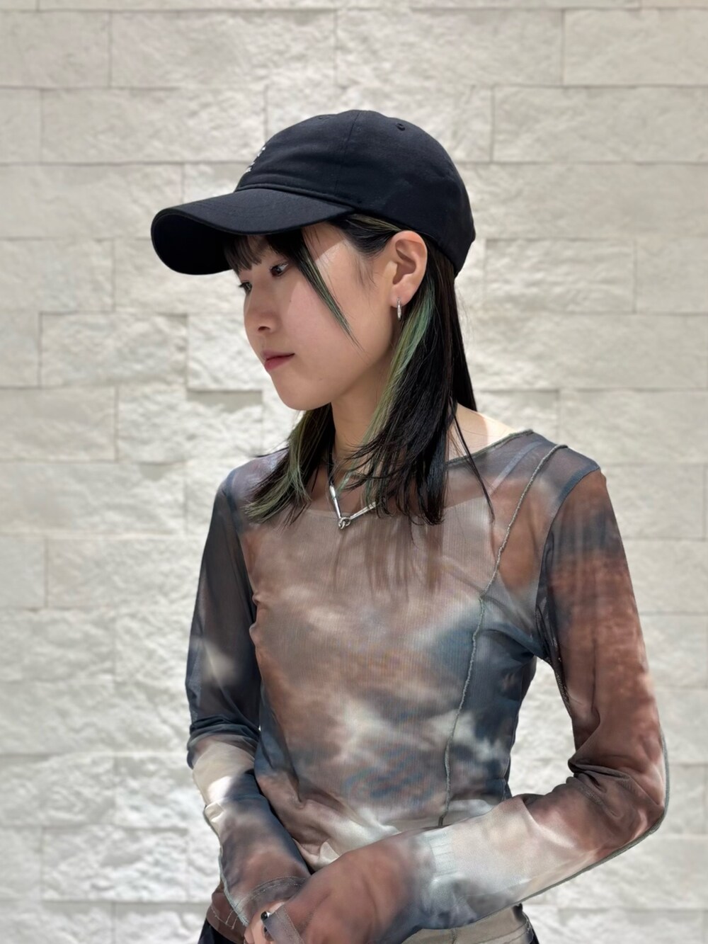 ブラック系のスニーカー、ブラック系のキャップを着用したレディースの夏コーディネートの4枚目の写真