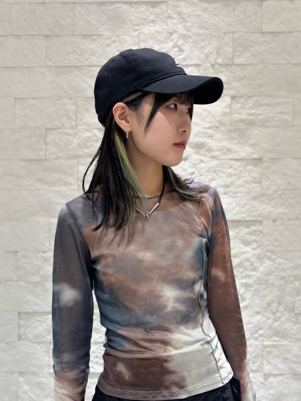 ブラック系のスニーカー、ブラック系のキャップを着用したレディースの夏コーディネートの5枚目の写真