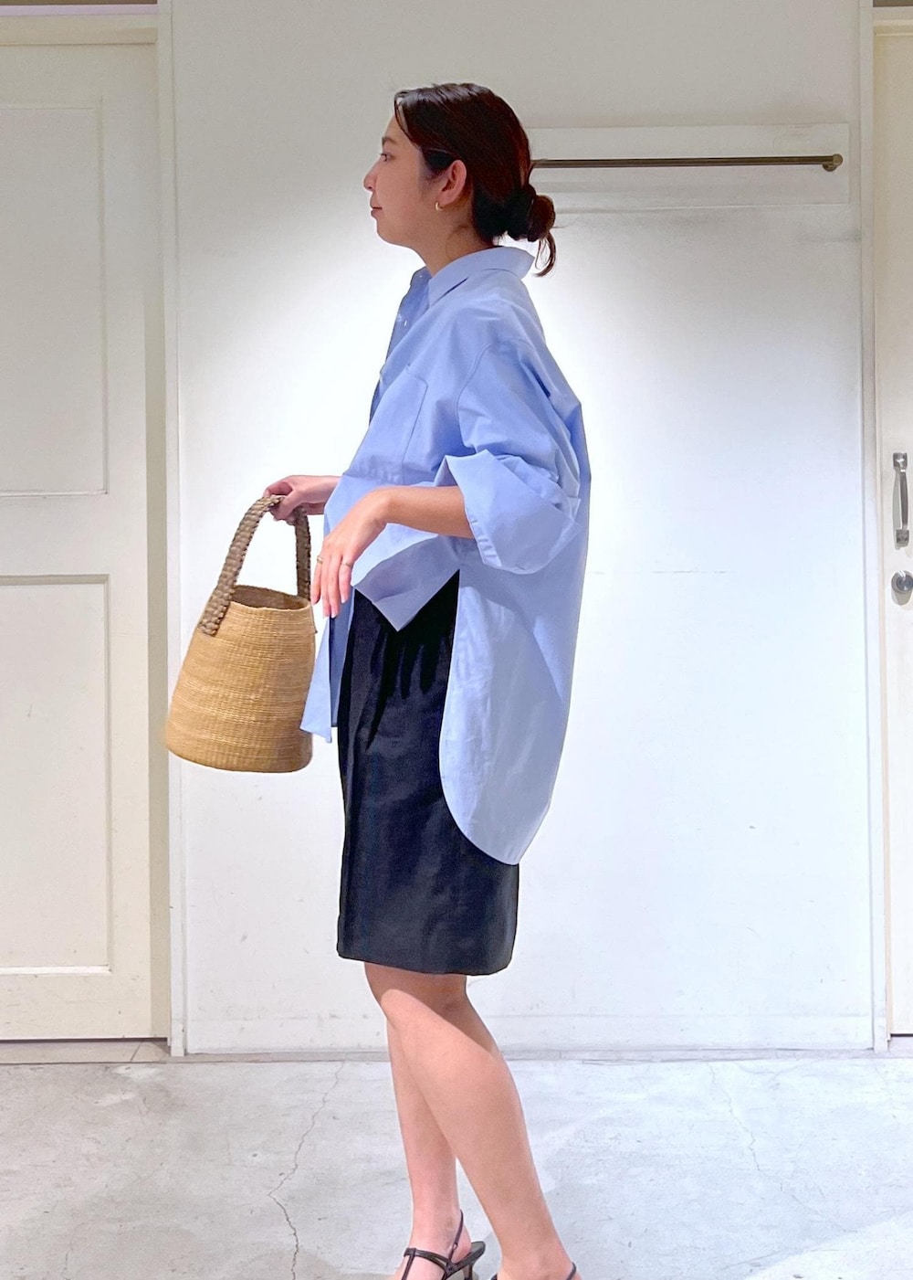 ブラック系のサンダル、ホワイト系のTシャツ/カットソー、ベージュ系のかごバッグを着用したレディースの春コーディネートの7枚目の写真