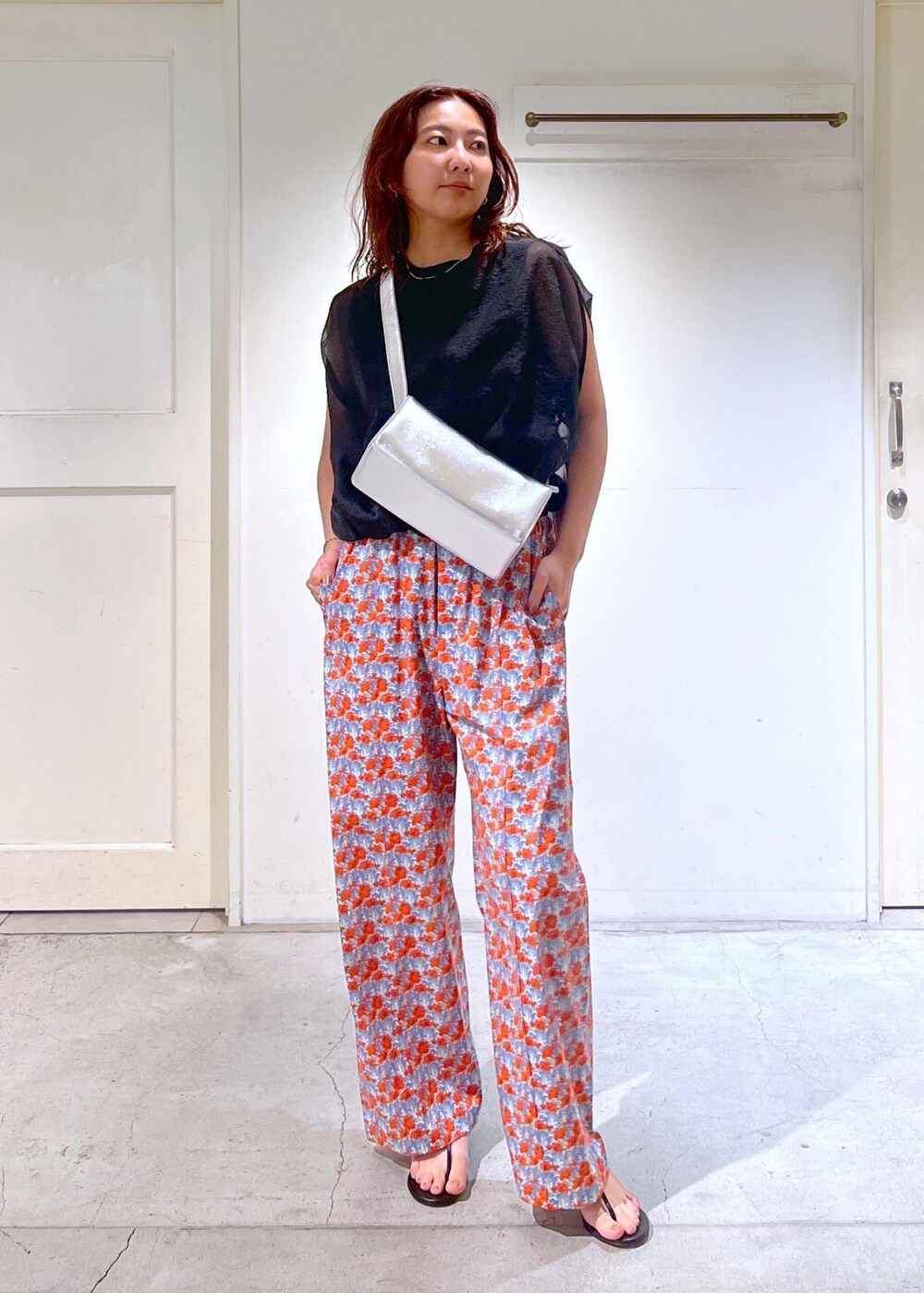 シルバー系のショルダーバッグ、ブラック系のサンダル、ブラック系のTシャツ/カットソーを着用したレディースの夏コーディネートの7枚目の写真