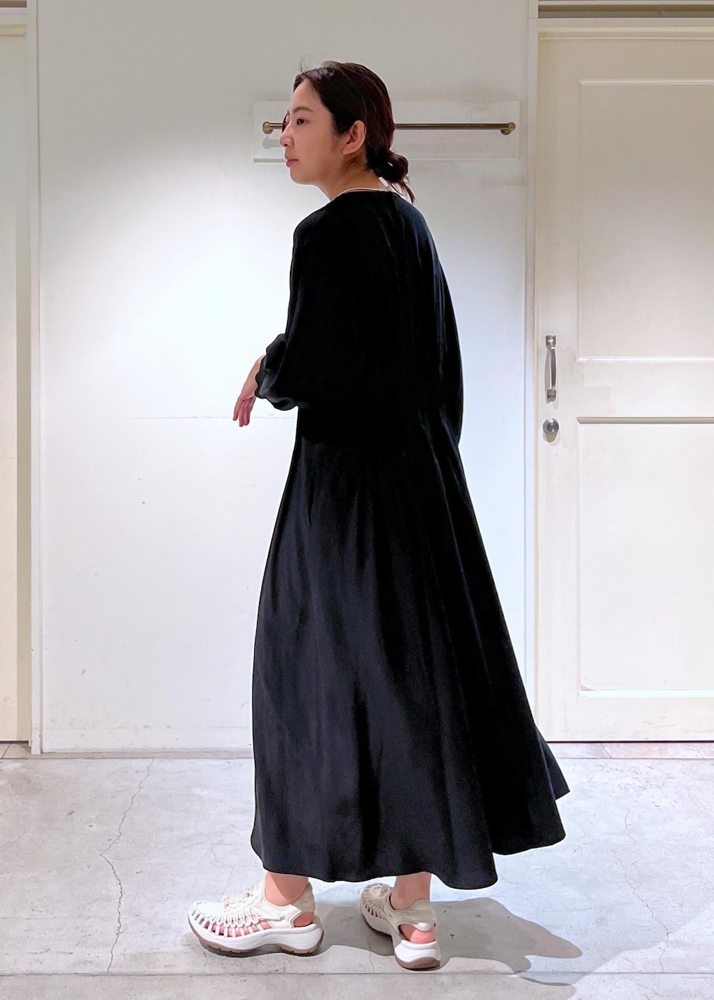 ホワイト系のサンダル、ブラック系のショルダーバッグ、ブラック系のワンピースを着用したレディースの春コーディネートの5枚目の写真