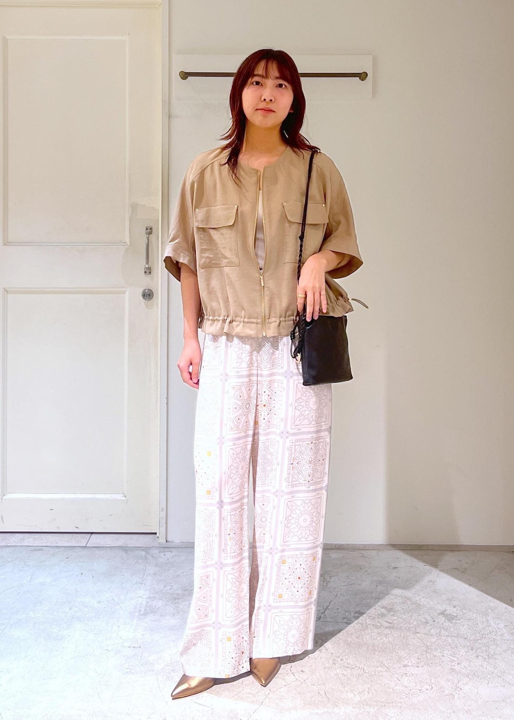 ブラック系のショルダーバッグ、その他のパンプス、ベージュ系のその他パンツを着用したレディースの春コーディネートの5枚目の写真