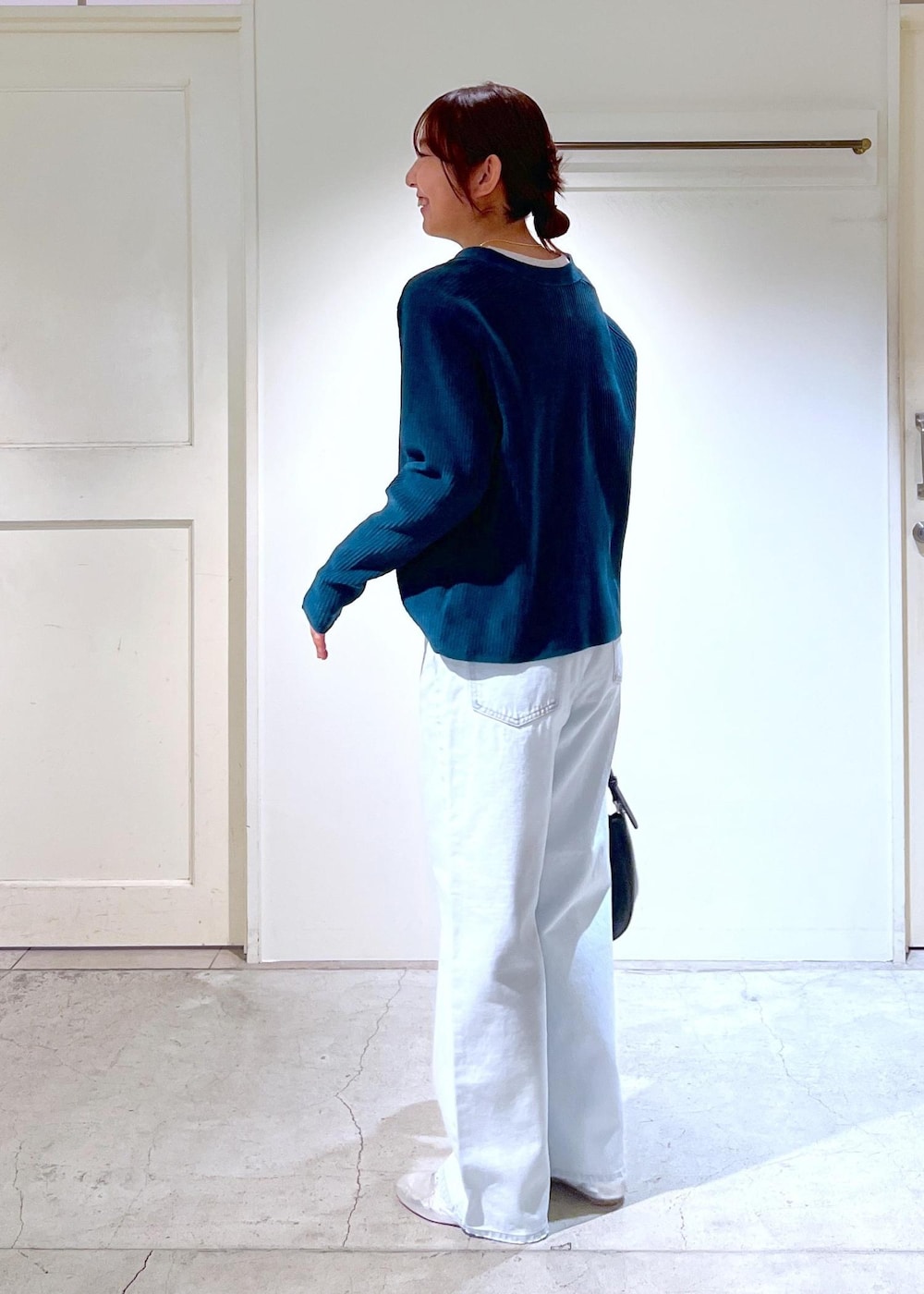 シルバー系のその他シューズ、ブルー系のデニムパンツ、ホワイト系のキャミソールを着用したレディースの冬コーディネートの4枚目の写真