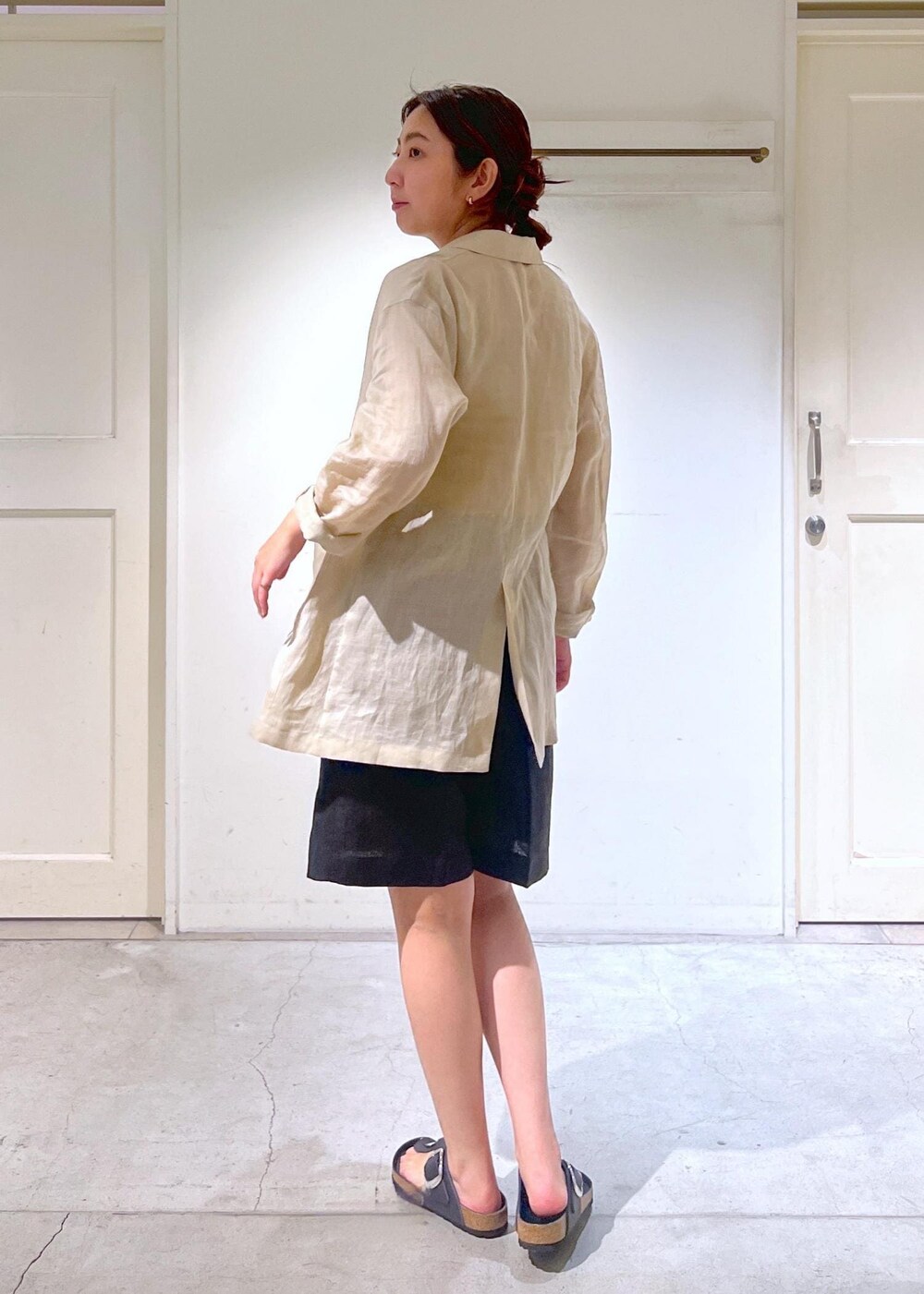 ブラック系のショルダーバッグ、ベージュ系のテーラードジャケット、ブラック系のその他パンツを着用したレディースの夏コーディネートの6枚目の写真