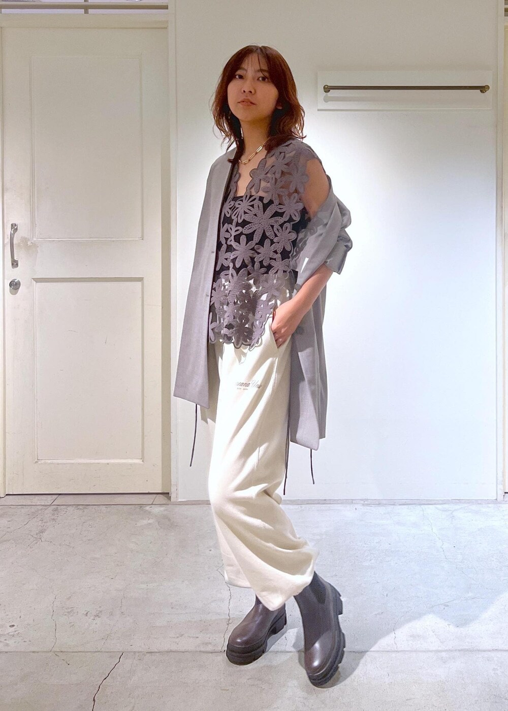 グレー系のノーカラージャケット、ホワイト系のスウェットパンツ、ブラック系のショルダーバッグを着用したレディースの秋コーディネートの4枚目の写真