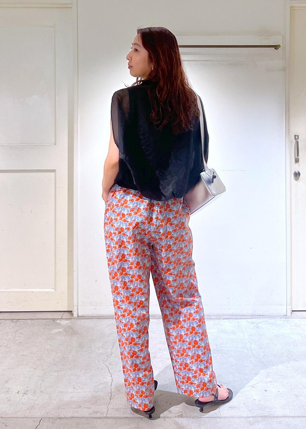 シルバー系のショルダーバッグ、ブラック系のサンダル、ブラック系のTシャツ/カットソーを着用したレディースの夏コーディネートの5枚目の写真