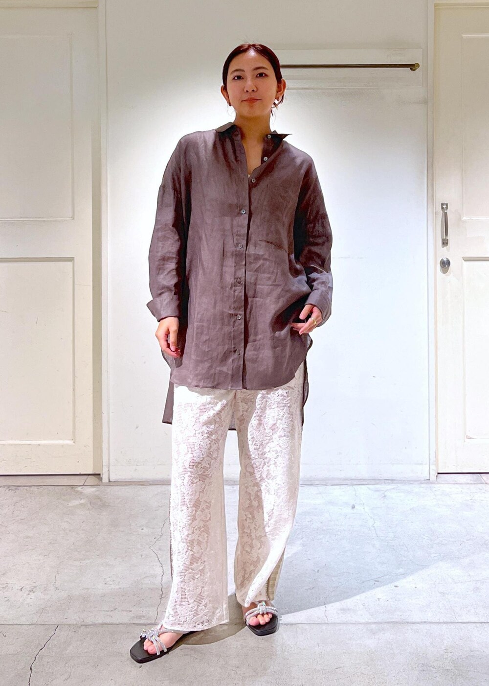 シルバー系のサンダル、ホワイト系のタンクトップ、イエロー系のキャミソールを着用したレディースの夏コーディネートの6枚目の写真