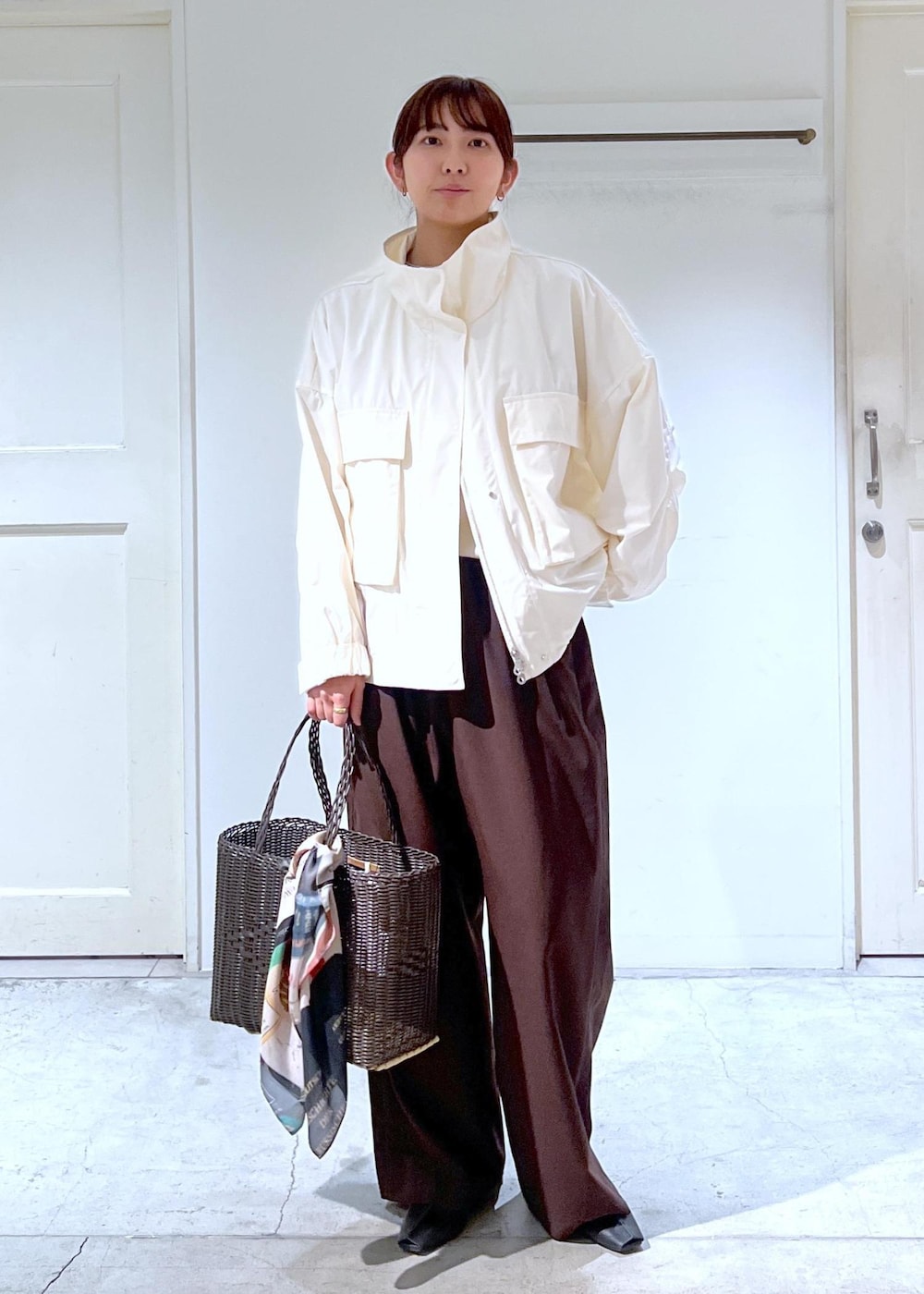 ブラック系のその他シューズ、ホワイト系のブルゾン、ホワイト系のTシャツ/カットソーを着用したレディースの春コーディネートの2枚目の写真