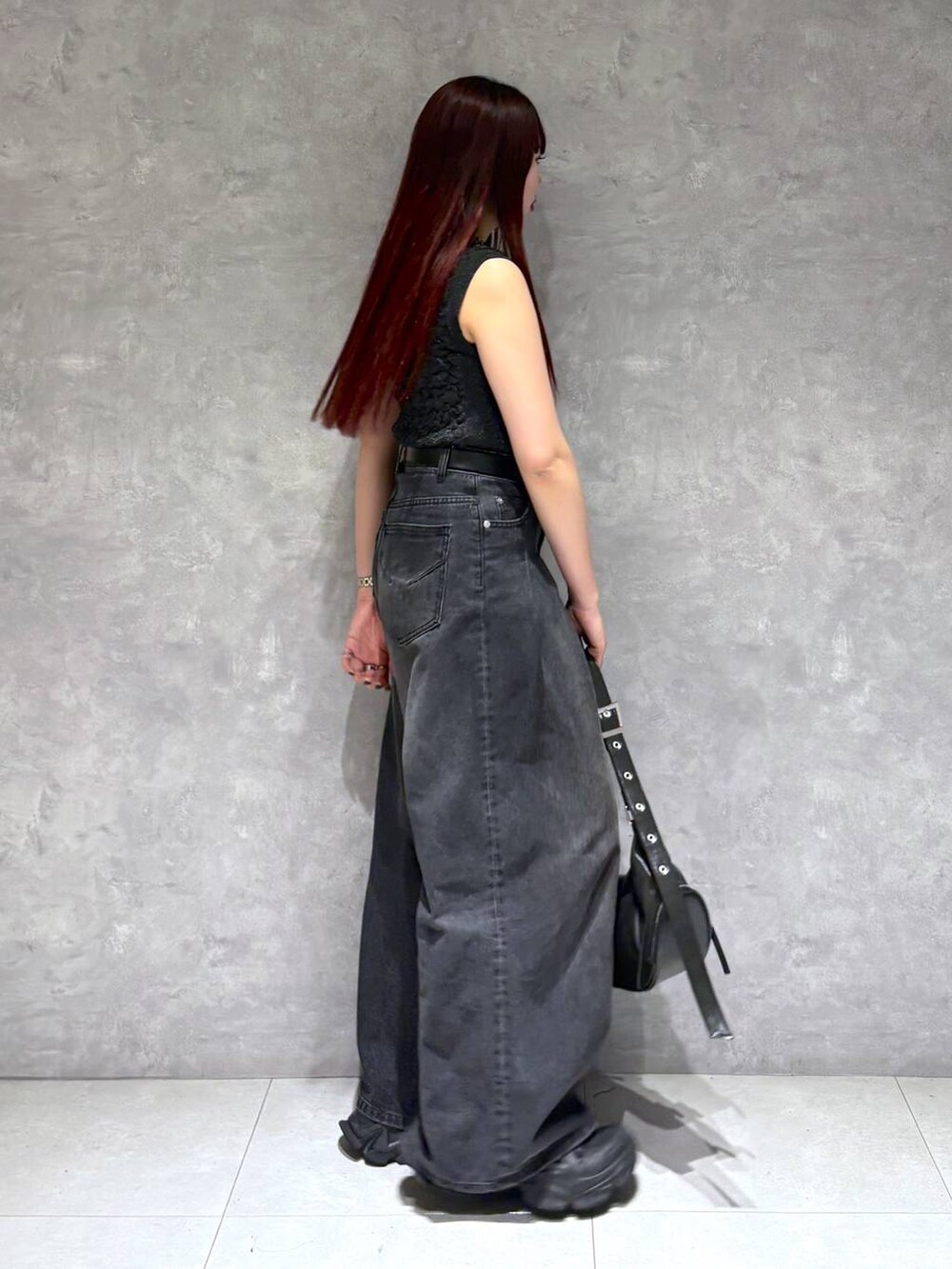 ブラック系のデニムパンツ、ブラック系のショルダーバッグ、ブラック系のTシャツ/カットソーを着用したレディースの春コーディネートの7枚目の写真