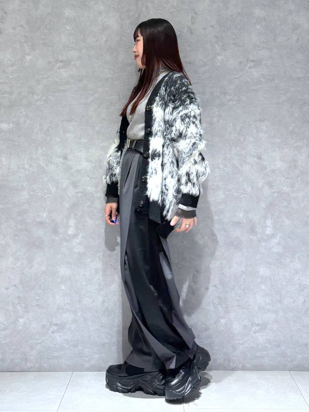 ブラック系のブーツ、ブラック系のカーディガン/ボレロ、グレー系のニット/セーターを着用したレディースの冬コーディネートの3枚目の写真